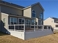 <b>TimberTech Dark Roast deck boards,white Washington rails with black aluminum square balusters, white PVC fascia, white vinyl fence skirting</b>